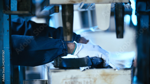 Worker fill the press machine with raw rubber material photo