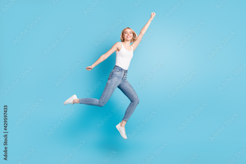 Full length body size view of attractive cheerful girl jumping striving having fun isolated over bright blue color background