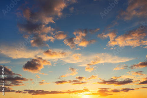 Dramatic colorful red orange dark blue sunset or sunrise sky evening morning landscape clouds. Natural beautiful cloudscape dawn background wallpaper. Stormy windy nature twilight dusk scene panorama