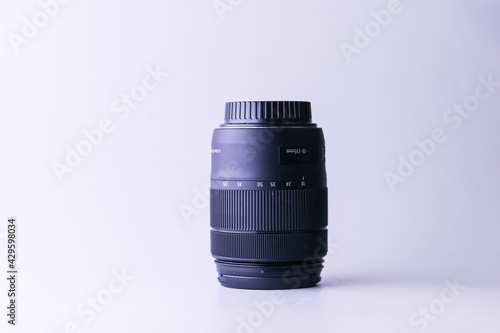 Lens for professional camera on white background. Beautiful wide-angle lens on white backhround photo