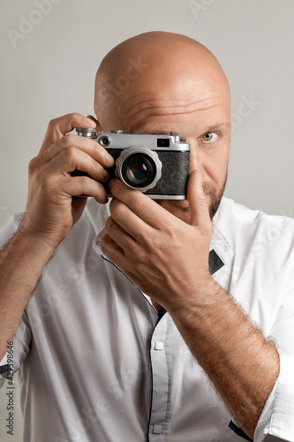 Photographer. Close up portrait of man holding vintage camera