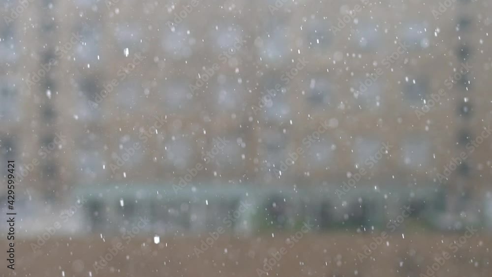 Rain in focus with blurred buildings in the background in slow-mo Rain in focus with blurred buildings in the background in slow-mo