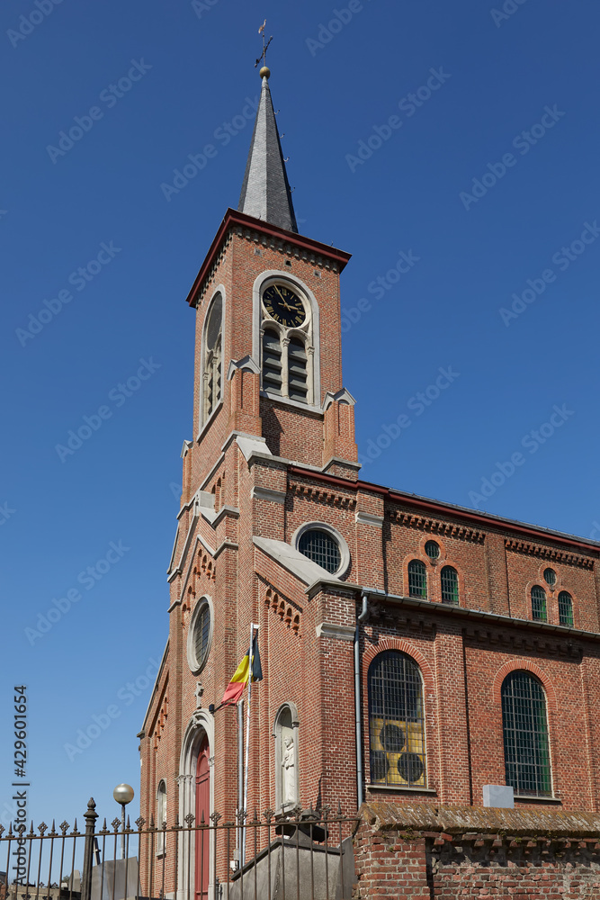 Country church in Belgium Flanders Zonnegem against blue sky