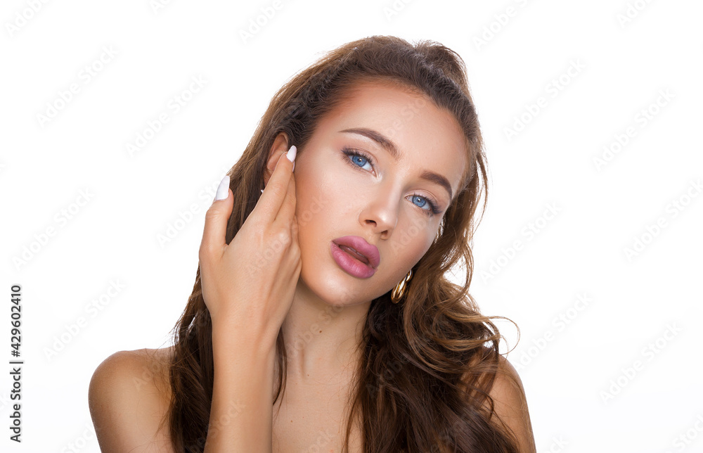 Beautiful face of young adult woman with clean fresh skin. Beauty portrait of brunette with blue eyes standing on white background copy space