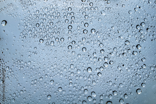 Water droplets and raindrops on clear glass