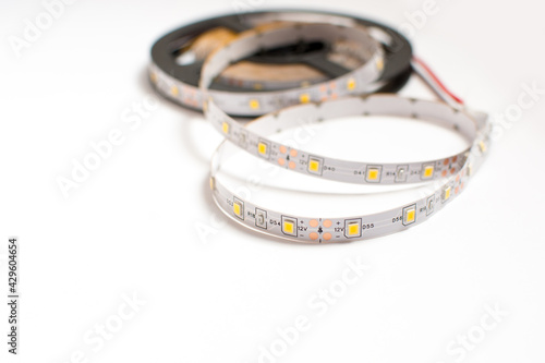 Led strip tape roll isolated on white background. Diode as a component for home made lighting. Diy and save energy concept.