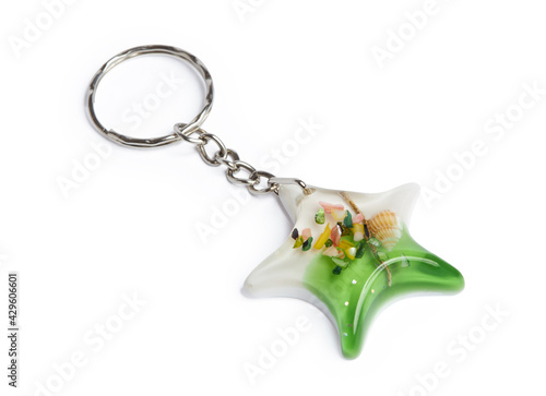 Epoxy resin key ring in a star shape with sea shells isolated on a white background with clipping path