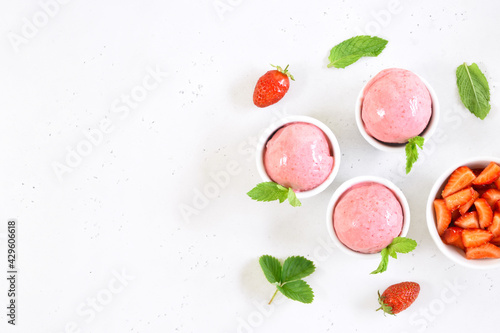 Strawberry ice cream scoop in bowl