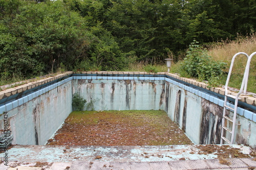 empty and weathered pool in summer