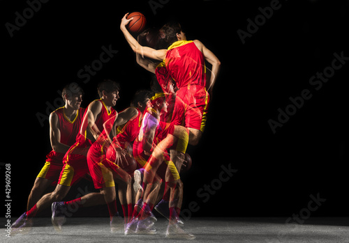 Young caucasian basketball player in motion and action in mixed light on dark background. Concept of healthy lifestyle  professional sport  hobby.