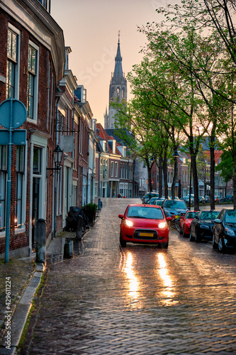Delft cobblestone street with car in the rain
