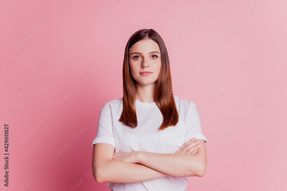 Beautiful focused attractive girl folded hands isolated over pink background Beautiful focused attractive girl folded hands isolated over pink background