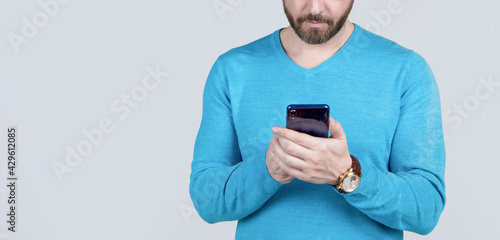 cropped man with beard chatting online on smartphone, copy space, chat © Olena