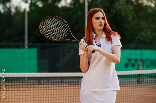 Girl on a tennis court with a racket © taras.chaban