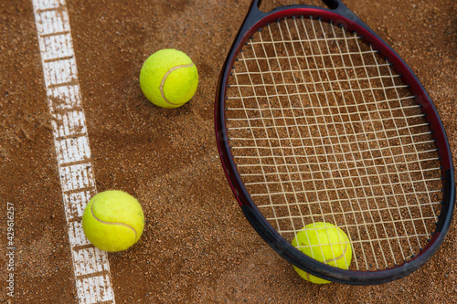 Tennis balls and racket on court © taras.chaban