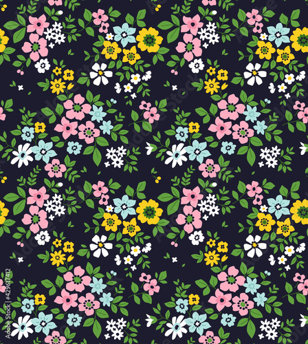 Cute floral pattern in the small flower. Seamless vector texture. Elegant template for fashion prints. Printing with small colorful flowers. Dark blue background. Stock print.