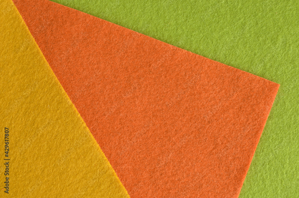 Orange, green and yellow felt fabric texture for background. Orange, green and yellow felt fabric texture for background.