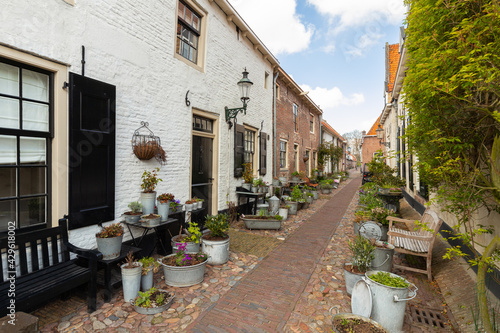 Small street with old small and authentic houses and flowers in the center of Elburg in the Netherlands. © Jan van der Wolf