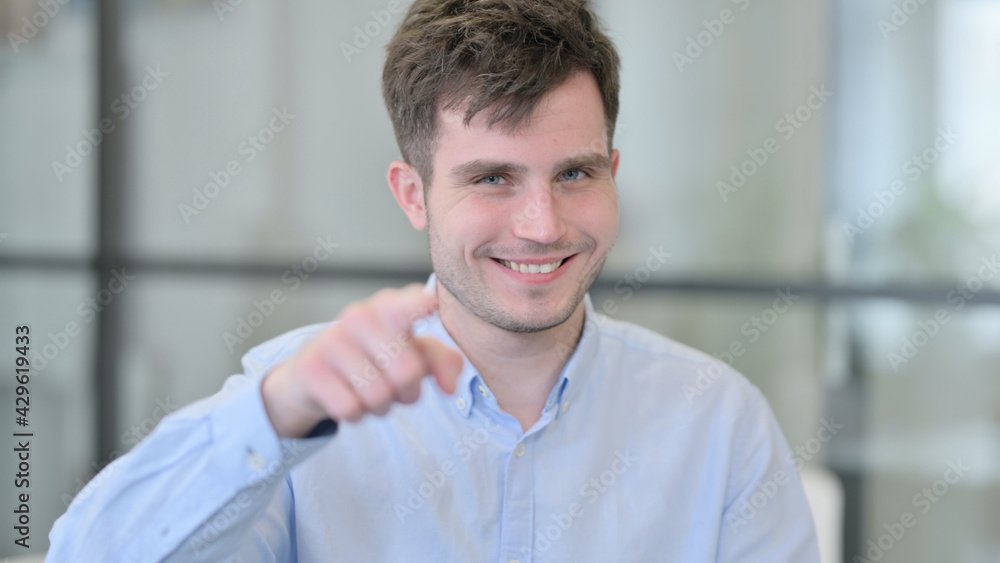 Naklejka premium Positive Young Man Pointing at the Camera 