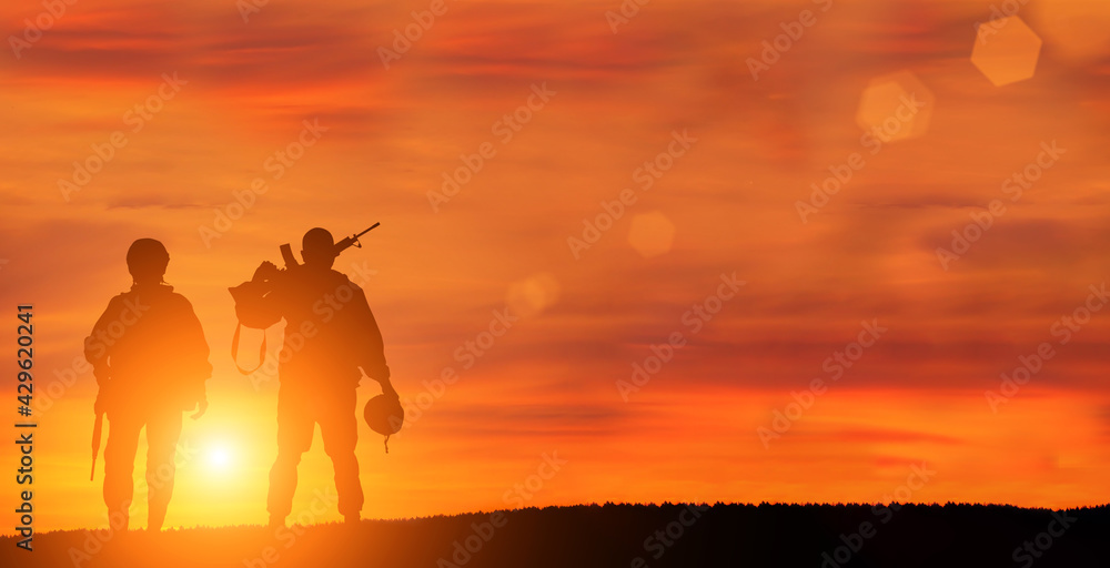 Military man and military woman on sunset background is symbol of equal rights.