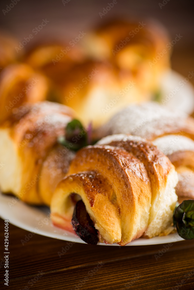 baked sweet homemade buns with plum inside baked sweet homemade buns with plum inside