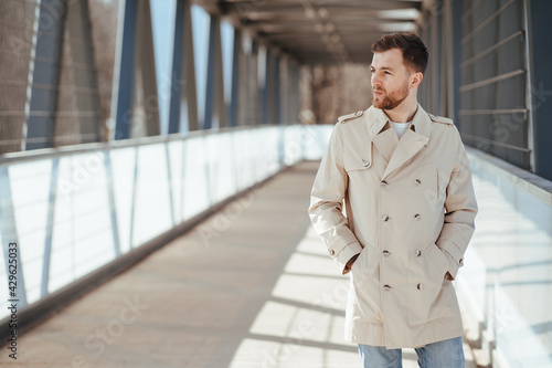 Wallpaper Mural Man walks down the street in beige coat Torontodigital.ca