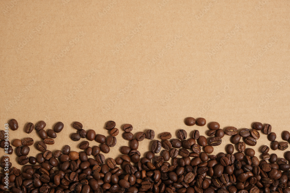 Coffee beans on a cardboard background, copy space. Coffee beans on a cardboard background, copy space.