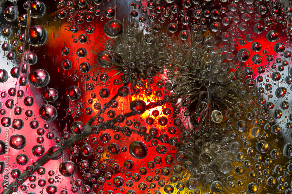 Multicolored spheres are located against a red-pink-gold background with a dry flower located on it. Abstract fantasy. 3D render. Multicolored spheres are located against a red-pink-gold background with a dry flower located on it. Abstract fantasy. 3D render.