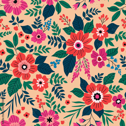Elegant pattern in pretty bright red and pink flowers. Liberty style. Floral seamless background. Ditsy print. Vector texture. A bouquet of spring flowers for fashion prints. Stock illustration.
