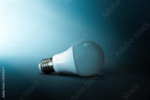 A light bulb on a dark blue background. Copy space. The concept of creativity, crisis, and ideas. International Intellectual Property Day