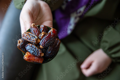 Young woman serving date iftar photo