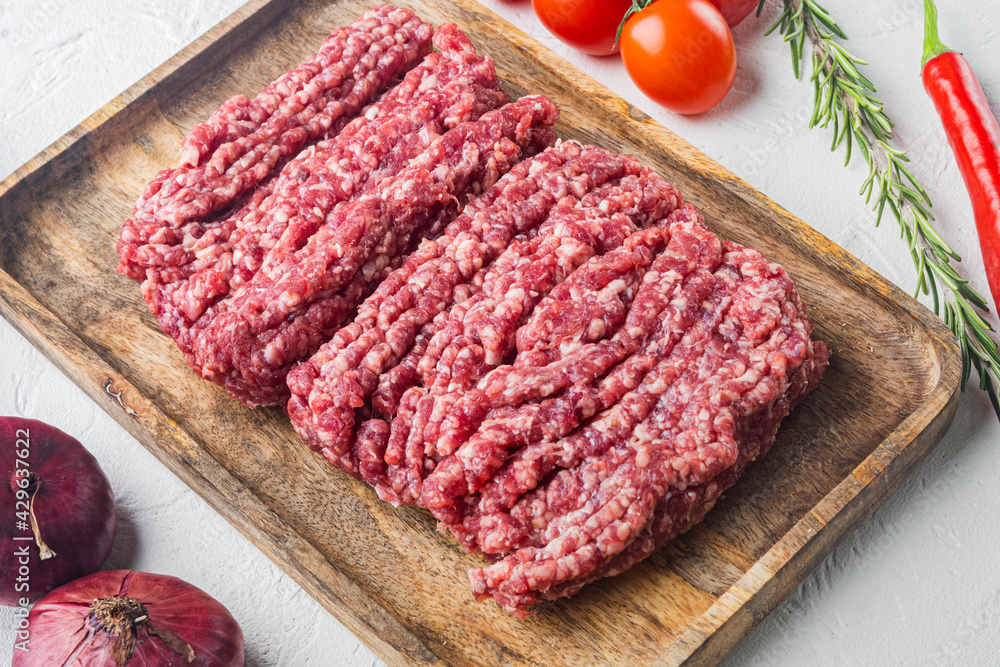 Fresh minced meat ground beef, on white background