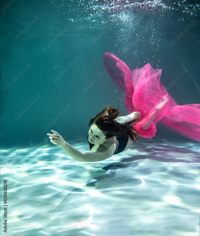 beautiful girl in a black swimsuit and with a pink pareo and with a ...