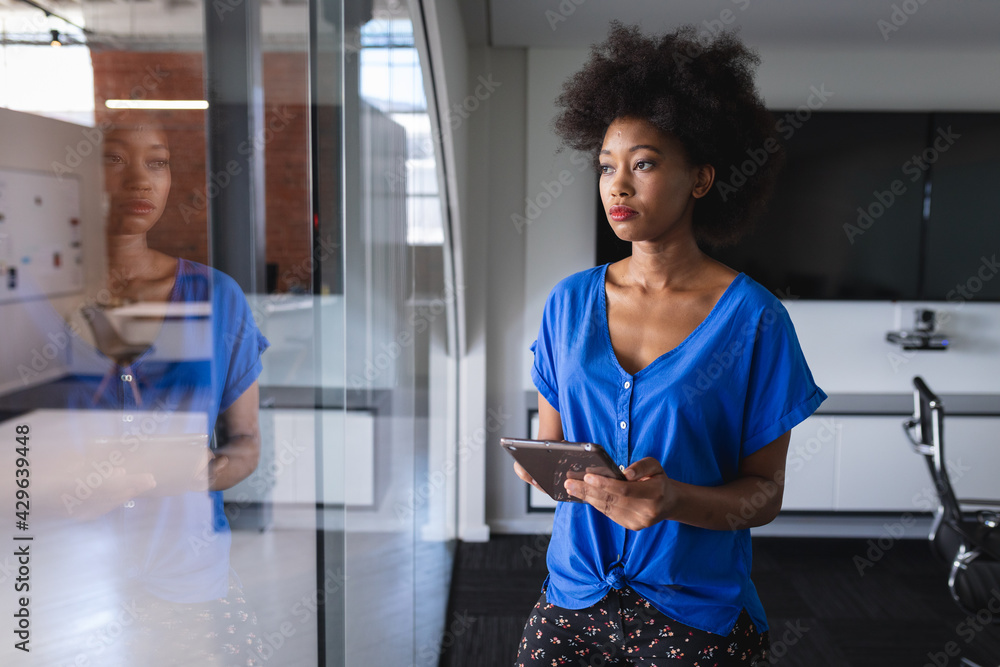 African american business woman in meeting room standing over blueprint document African american business woman in meeting room standing over blueprint document