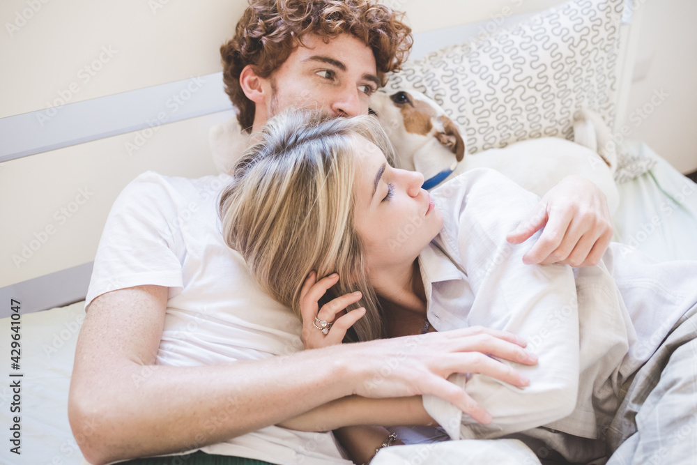 Young couple in love hugging bedroom