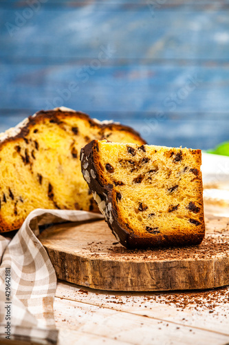 Panettone is the traditional Italian dessert for easter in 2021. Homemade panettone covered in chocolate and sprinkles. Bread served as dessert.