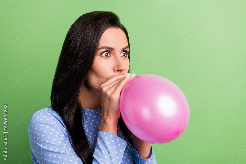 Profile photo of impressed brown hair lady blow balloon wear blue dress isolated on green color background Profile photo of impressed brown hair lady blow balloon wear blue dress isolated on green color background
