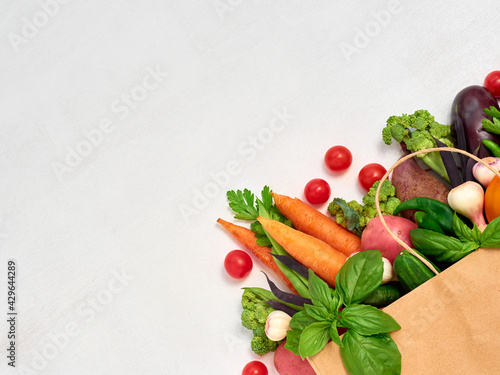 Vegetables in paper bag on white background.