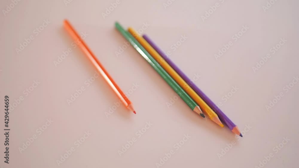 Camera moves above rows of colored pencils on white background. Endless coloring pencils arranged in row.
Camera moves above rows of colored pencils on white background. Endless coloring pencils arranged in row.