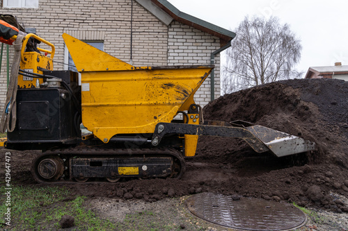 Картината върху платно small helper for the gardener mini tracked dumpster, self loader