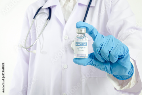 Doctor holding a bottle of coronavirus vaccine (COVID-19). Hospital medical service concept, Antiviral vaccine.