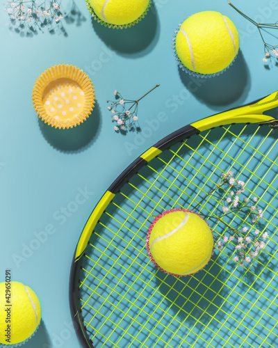 Foto Holliday sport composition with yellow tennis balls and racket on a blue background of hard tennis court