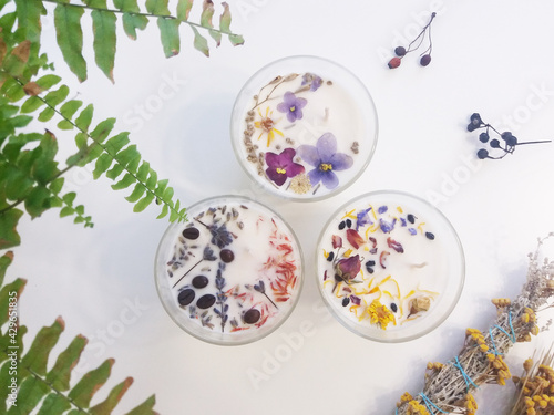 Handmade flower soy candles with herbs and crystals
