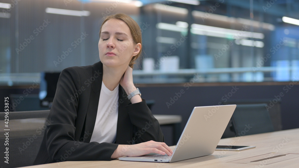 Businesswoman with Neck Pain while Typing on Laptop Businesswoman with Neck Pain while Typing on Laptop