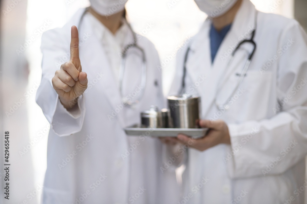Close up of doctor pointing up finger Close up of doctor pointing up finger