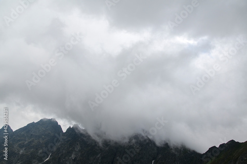 Scenery of high green mountains, sky with clouds. High Tatras Slovakia. Beautiful mountain landscape