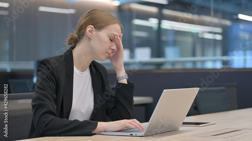 Tired Businesswoman with Headache at Work