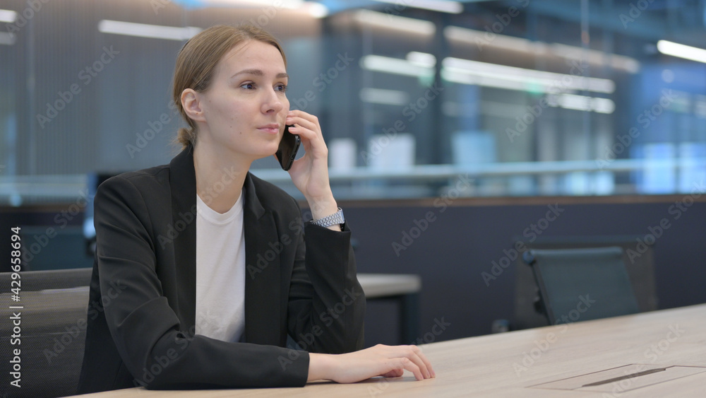 Businesswoman Talking on Smartphone at Work Businesswoman Talking on Smartphone at Work