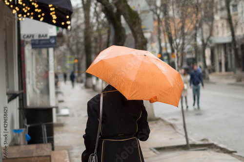 A woman with an umbrella in the pouring rain.