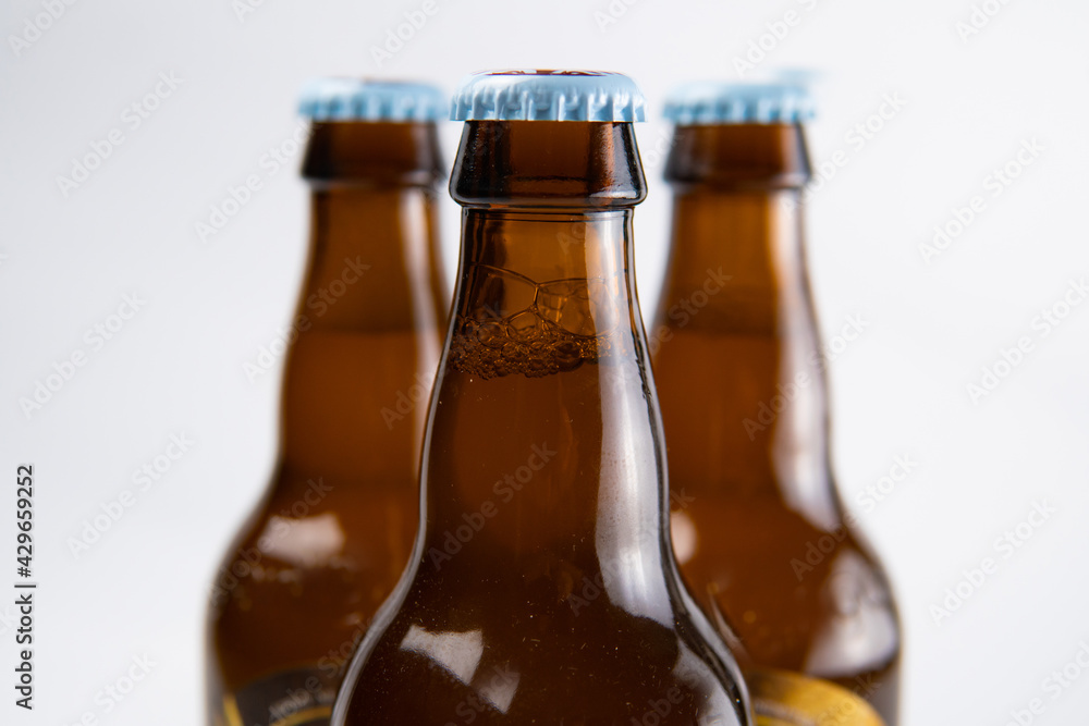 closed beer bottles on a white and black background